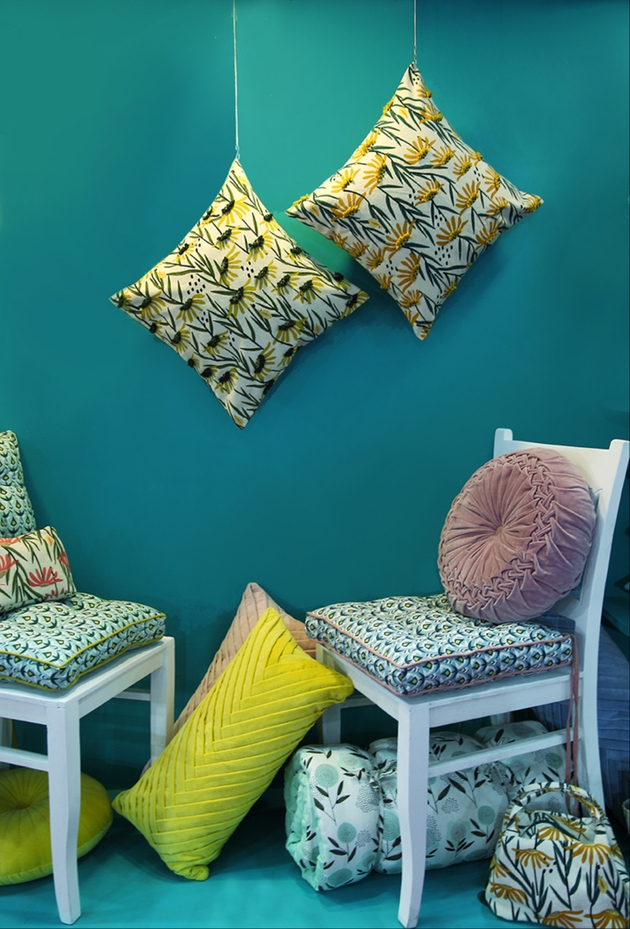 Cushions and soft furnishings on a teal background