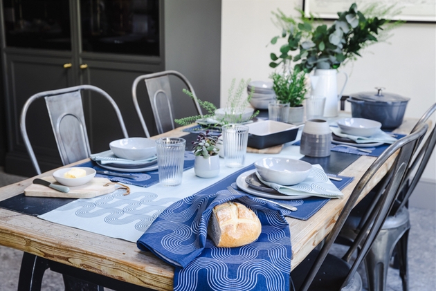 Wooden table with blue woven homeware