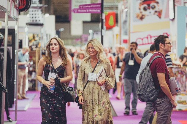 Two women walking through exhibition hall