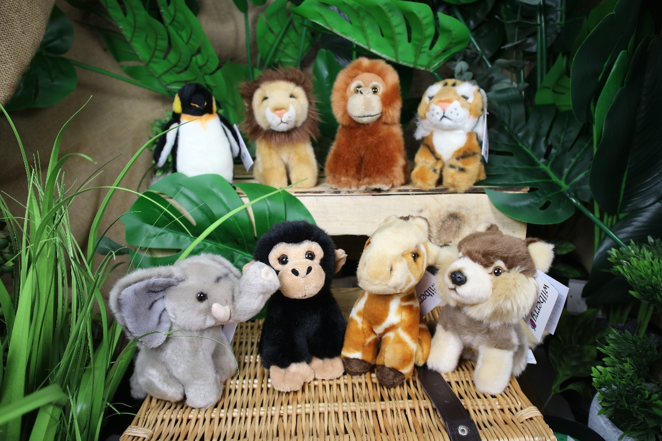 wildlife puppets displayed on a wicker hamper with jungle plants