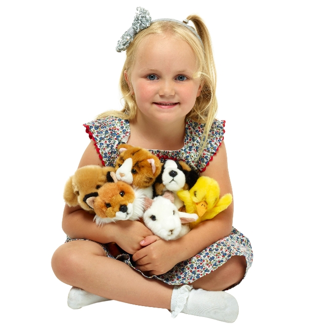 young girl holding a range of mini teddys