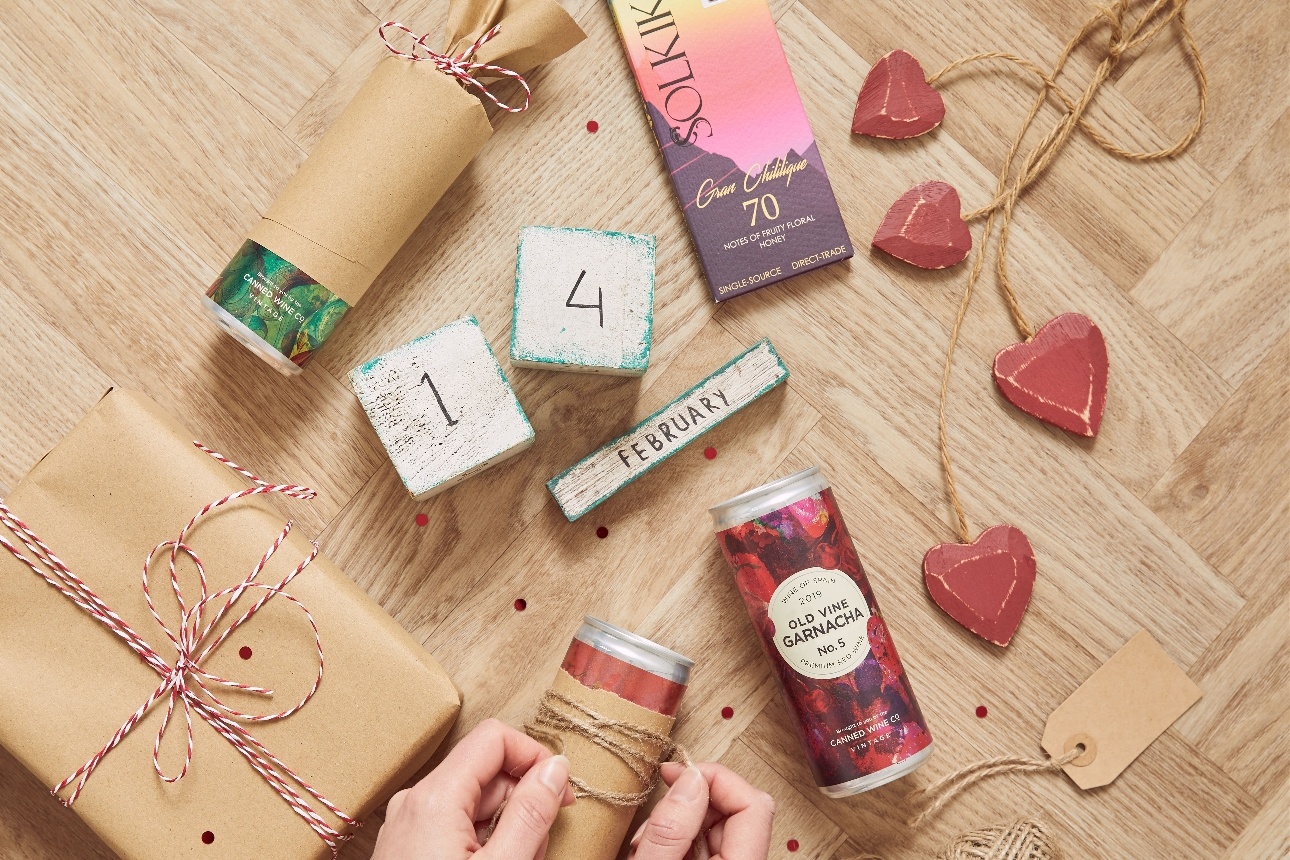 The Canned Wine Co can being wrapped up for a gift in brown paper