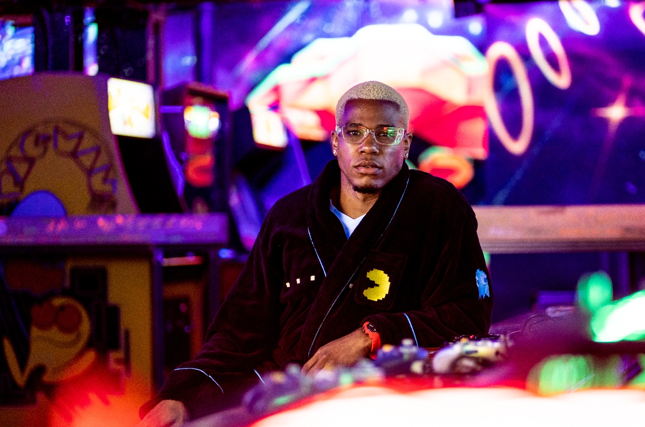 man in an arcade in a pac man robe wearing sunglasses