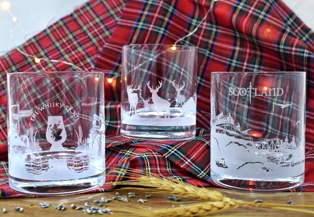 three glasses etched with Scottish motifs