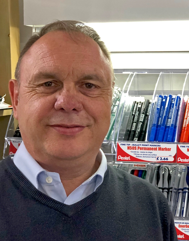 John Cotterell at Pentel stands in front of pen display