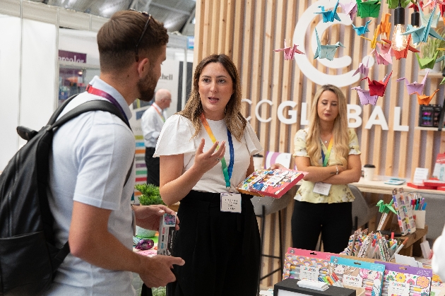 Exhibitors explaining products at their trade show stand