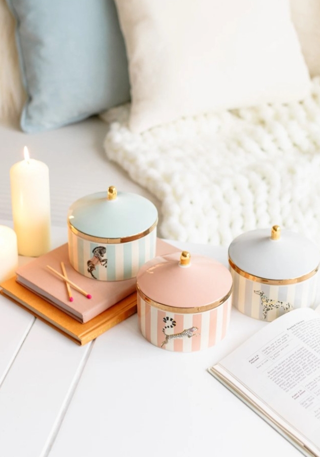 three candles in pastel colours with lids