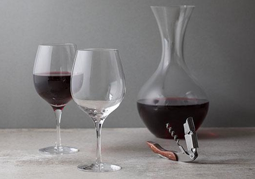 wine glasses and carafe with red wine in it 