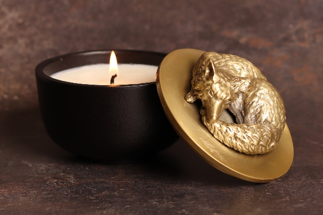 candle with a gold fox on top 