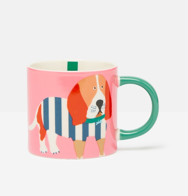 pink mug with green handle with a dog on it