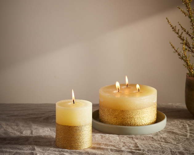 yellow candles with gold effect bottom on wax