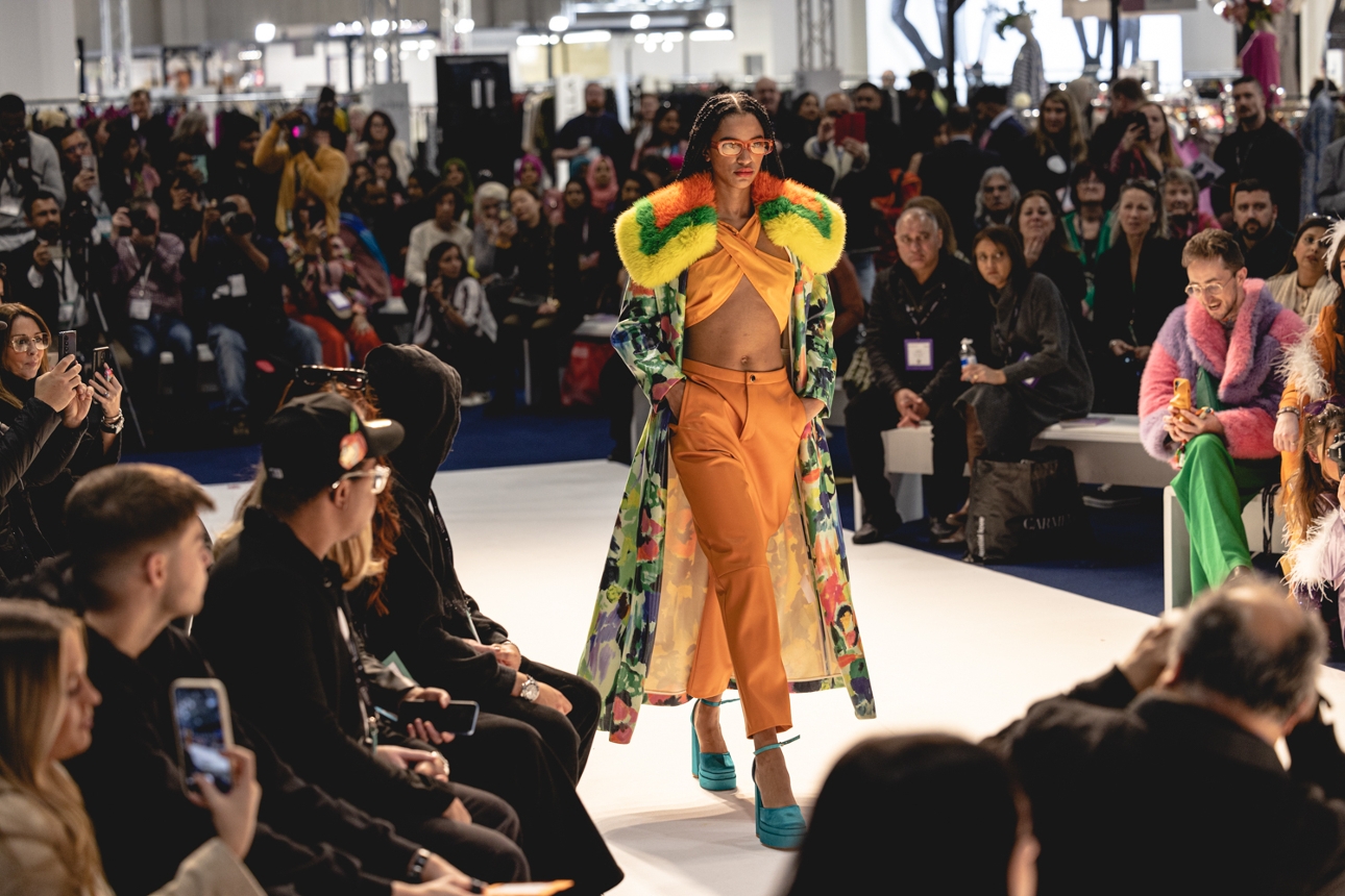 model on runway with audience watching 