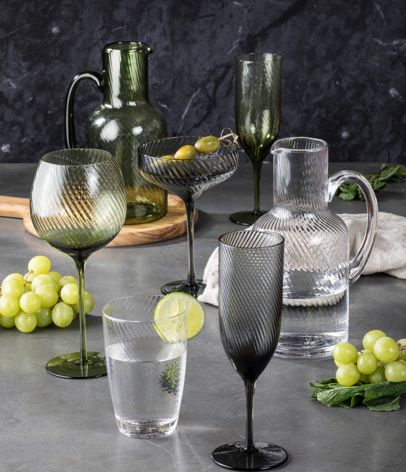 glassware in white green and black with swirl pattern etched in to glasses and jugs