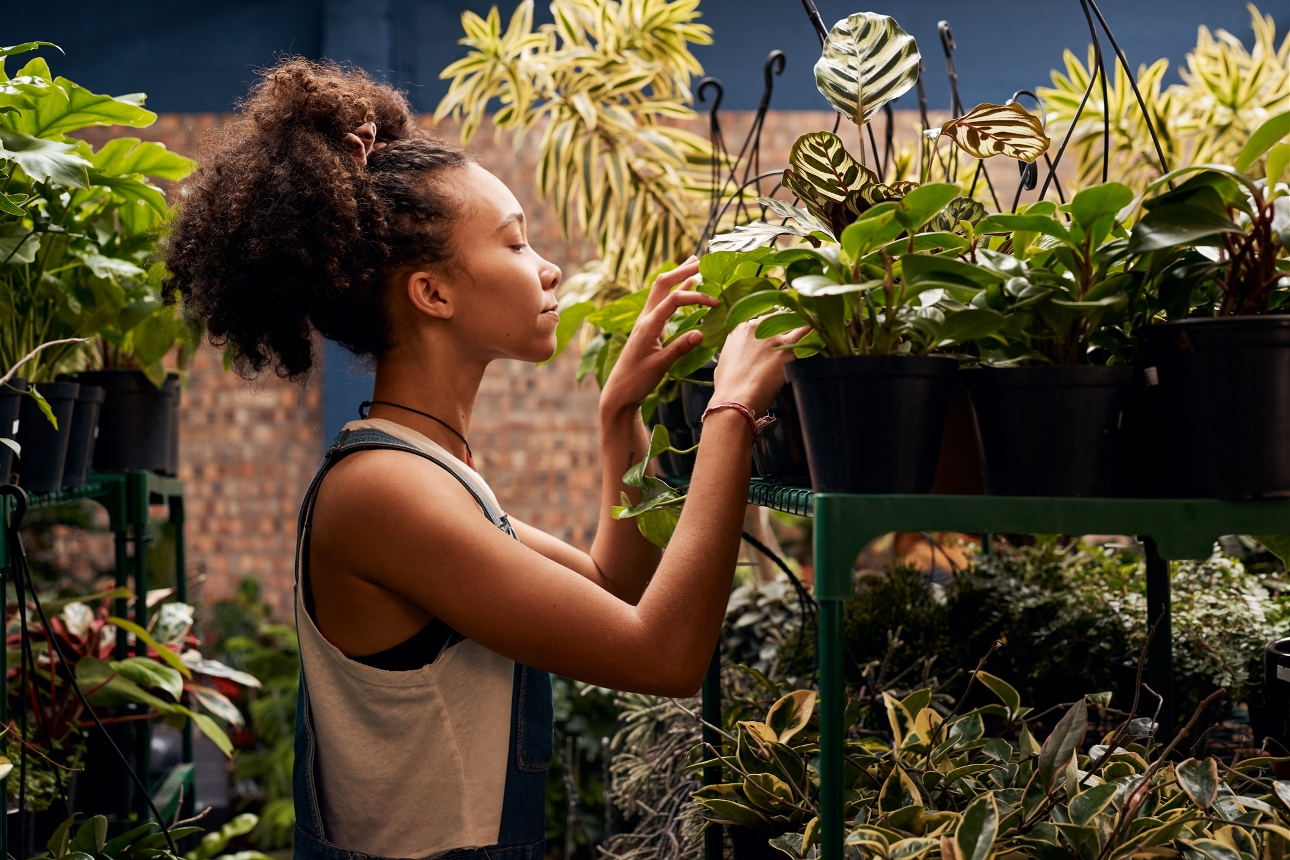 young person looking at plants