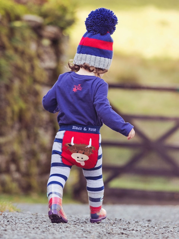 toddler in knitted leggings with hyland cow on bottom