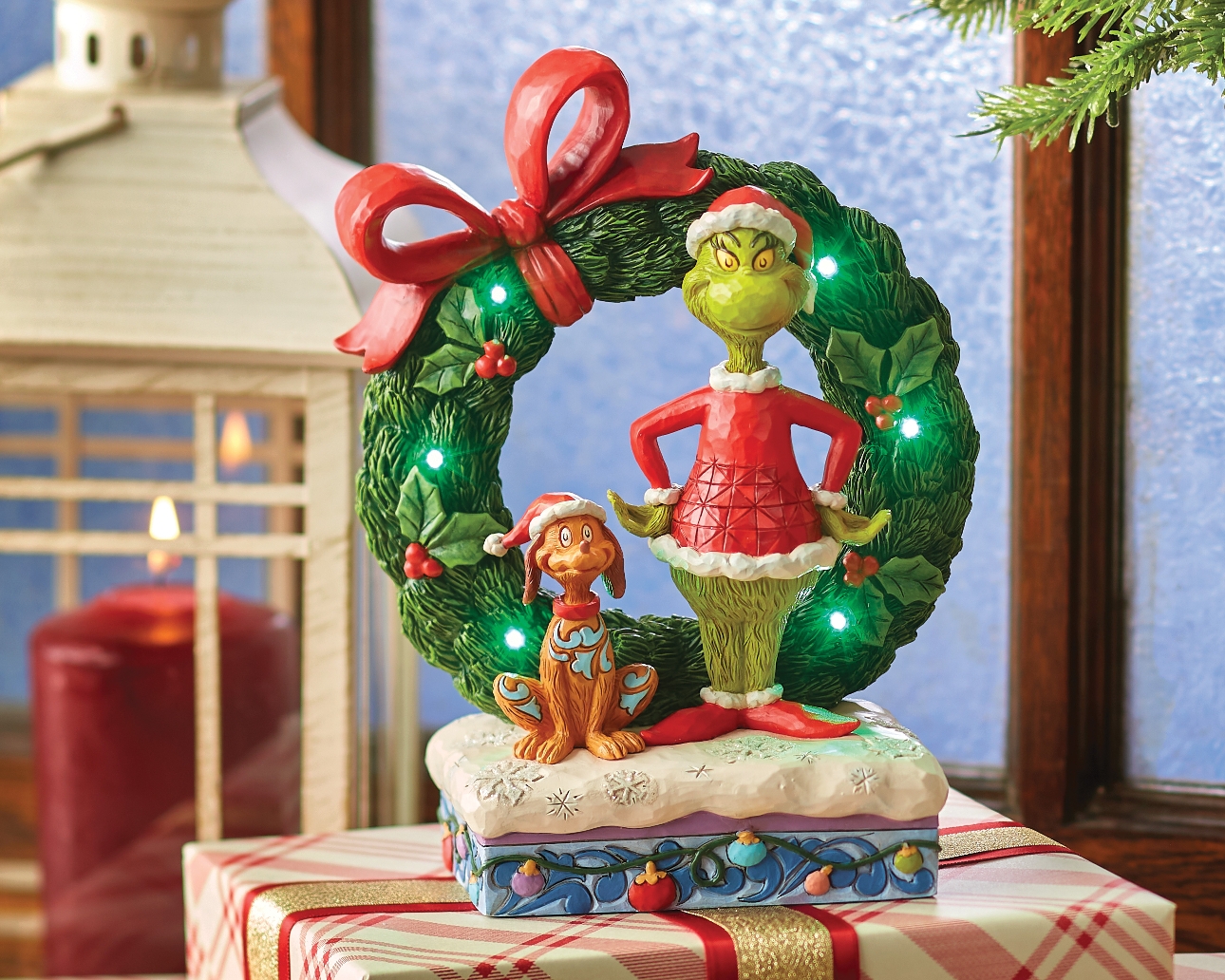 ornament of The Grinch, with Max, standing in front of a Christmas Wreath 