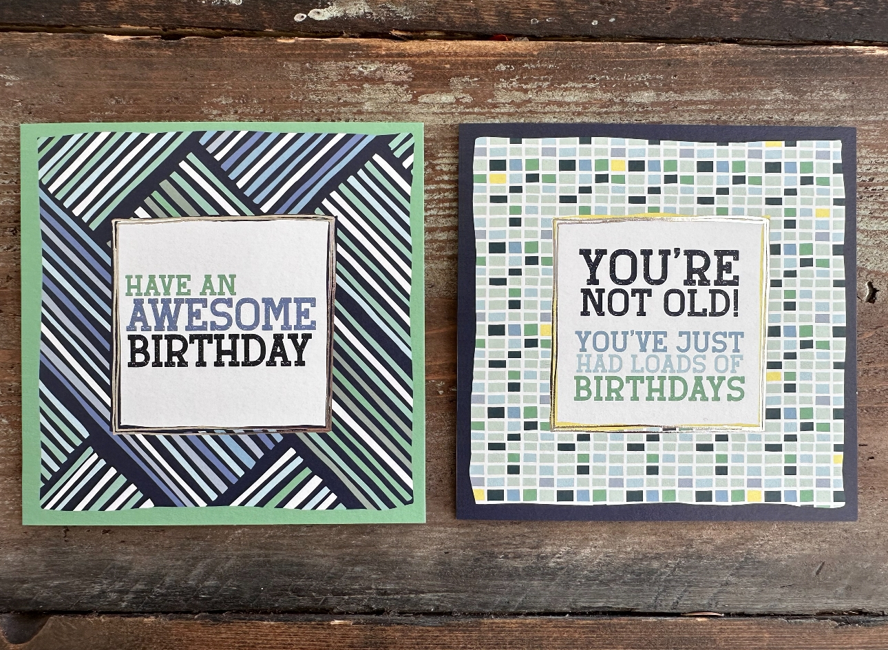two cards on a wooden table, in blue hues and bold design, birthday theme