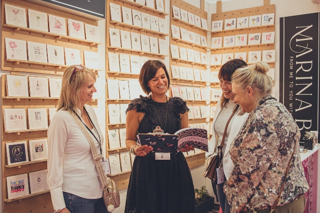 Four ladies chatting at a greeting card trade show stand