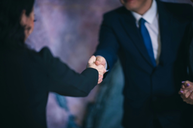 two people in suits shaking hands
